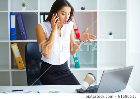 Office. Business Woman at the Big Light Office Sitting at the Ta 61680515