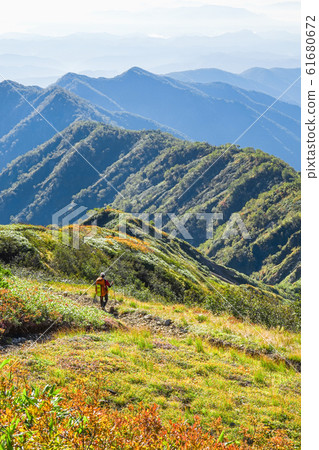 Goryudake mountain climbing in autumn (climbers going on the Tomi ridge) 61680672