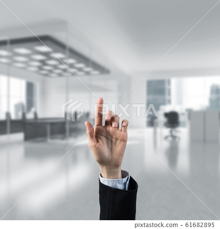 Choosing gesture of businessperson in elegant modern interior in Choosing gesture of businessperson in elegant modern interior in 61682895