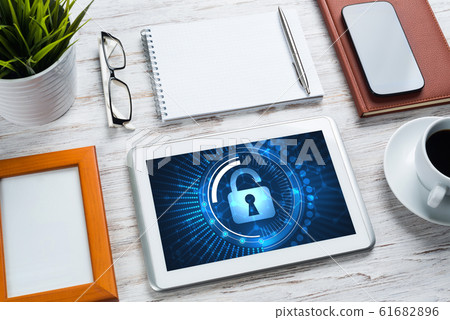 Web security and technology concept with tablet pc on wooden table Web security and technology concept with tablet pc on wooden table 61682896