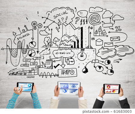 Top view of businesspeople sitting at table and using gadgets Top view of businesspeople sitting at table and using gadgets 61683003