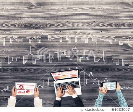 Top view of businesspeople sitting at table and using gadgets 61683007