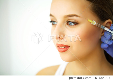 Beauty and Care. Portrait of a Young Woman with a Beautiful Face. A Cosmetologist Makes Injections. High Resolution Beauty and Care. Portrait of a Young Woman with a Beautiful Face. A Cosmetologist Makes Injections. High Resolution 61683027