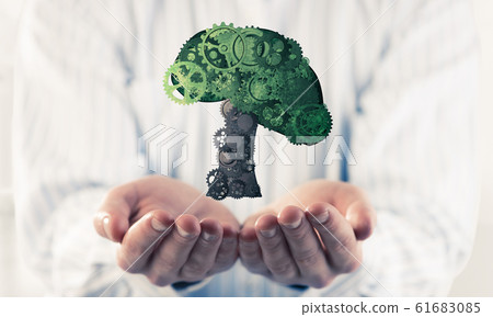 Businessman presenting in palms eco green concept symbolized wit Businessman presenting in palms eco green concept symbolized wit 61683085
