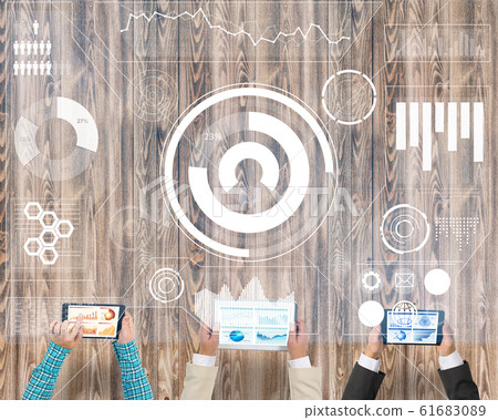 Top view of businesspeople sitting at table and using gadgets Top view of businesspeople sitting at table and using gadgets 61683089