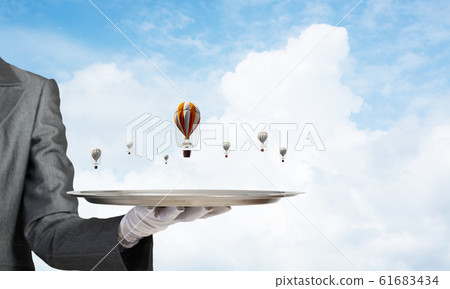 Hand of waiter presenting balloons on tray. Hand of waiter presenting balloons on tray. 61683434