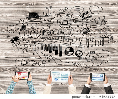 Top view of businesspeople sitting at table and using gadgets Top view of businesspeople sitting at table and using gadgets 61683552