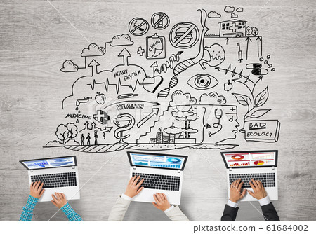 Top view of businesspeople sitting at table and using gadgets Top view of businesspeople sitting at table and using gadgets 61684002