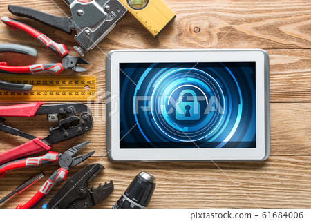 Web security and technology concept with tablet pc on wooden table Web security and technology concept with tablet pc on wooden table 61684006