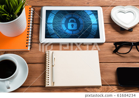 Web security and technology concept with tablet pc on wooden table Web security and technology concept with tablet pc on wooden table 61684234