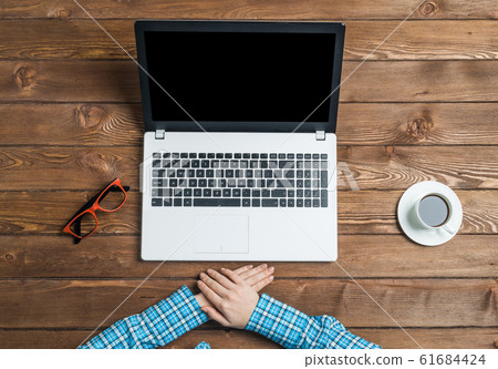Top view of woman sitting at wooden table and working with laptop 61684424