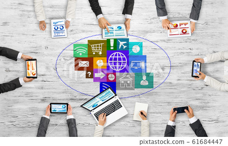 Top view of businesspeople sitting at table and using gadgets Top view of businesspeople sitting at table and using gadgets 61684447