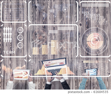Top view of businesspeople sitting at table and using gadgets Top view of businesspeople sitting at table and using gadgets 61684535