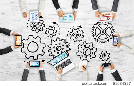 Top view of businesspeople sitting at table and using gadgets Top view of businesspeople sitting at table and using gadgets 61684537