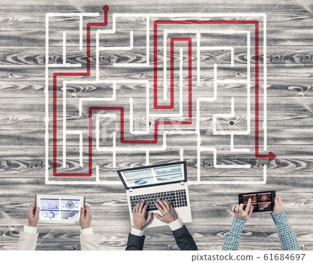 Top view of businesspeople sitting at table and using gadgets Top view of businesspeople sitting at table and using gadgets 61684697