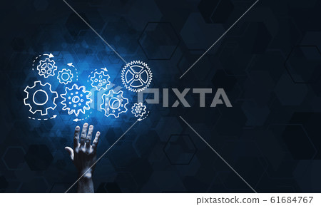 Glowing cogwheel mechanism icon on dark background as symbol of teamwork 61684767