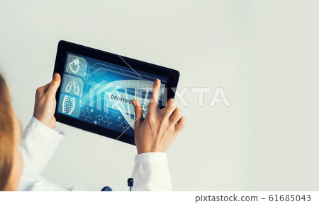 Close of female doctor hands working with tablet pc computer 61685043