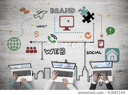 Top view of businesspeople sitting at table and using gadgets Top view of businesspeople sitting at table and using gadgets 61685149