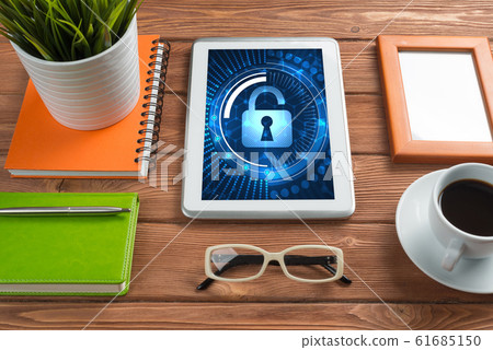 Web security and technology concept with tablet pc on wooden table Web security and technology concept with tablet pc on wooden table 61685150