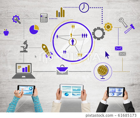 Top view of businesspeople sitting at table and using gadgets Top view of businesspeople sitting at table and using gadgets 61685173