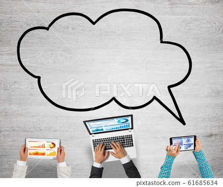 Top view of businesspeople sitting at table and using gadgets 61685634