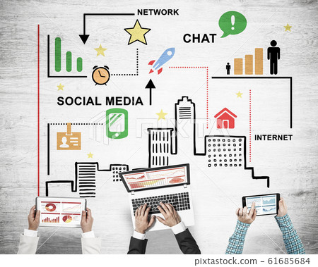 Top view of businesspeople sitting at table and using gadgets Top view of businesspeople sitting at table and using gadgets 61685684