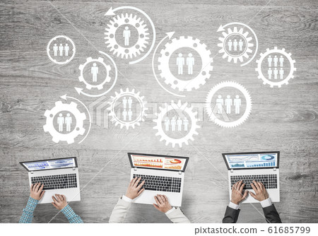 Top view of businesspeople sitting at table and using gadgets Top view of businesspeople sitting at table and using gadgets 61685799