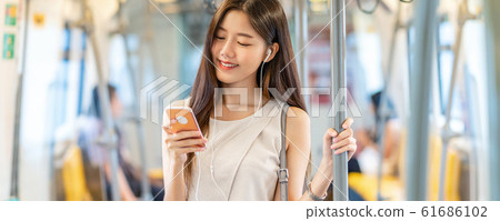 Banner, web page or cover template of Young Asian woman passenger using and listening music via smart mobile phone in subway train station, japanese,chinese,Korean lifestyle, leisure and daily life, Banner, web page or cover template of Young Asian woman passenger using and listening music via smart mobile phone in subway train station, japanese,chinese,Korean lifestyle, leisure and daily life, 61686102