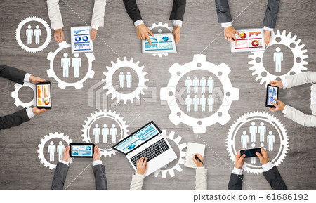 Top view of businesspeople sitting at table and using gadgets 61686192