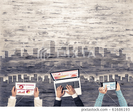 Top view of businesspeople sitting at table and using gadgets 61686193
