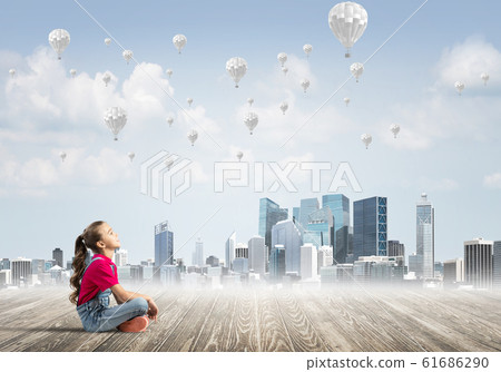Concept of careless happy childhood with girl dreaming about something Concept of careless happy childhood with girl dreaming about something 61686290
