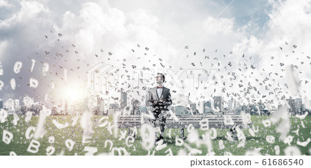 Young businessman or student studying the science and symbols fl Young businessman or student studying the science and symbols fl 61686540