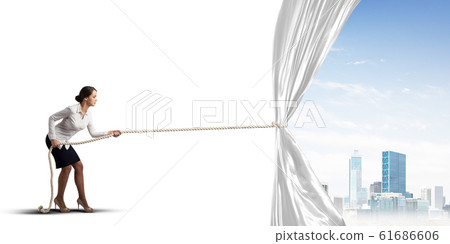 Young woman opening white curtain and presenting modern city landscape Young woman opening white curtain and presenting modern city landscape 61686606