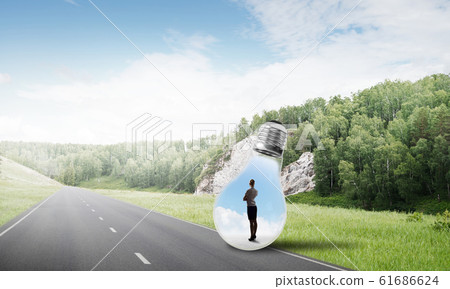 Businesswoman inside light bulb 61686624