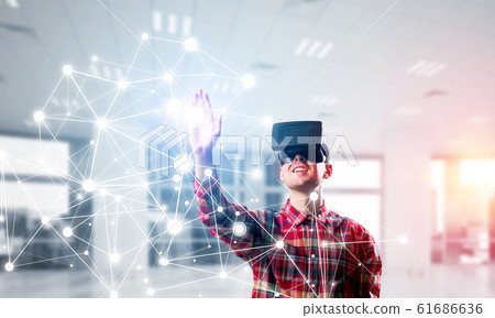 Guy wearing checked shirt and virtual mask reaching hand to touch screen 61686636