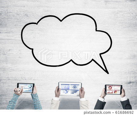 Top view of businesspeople sitting at table and using gadgets 61686692