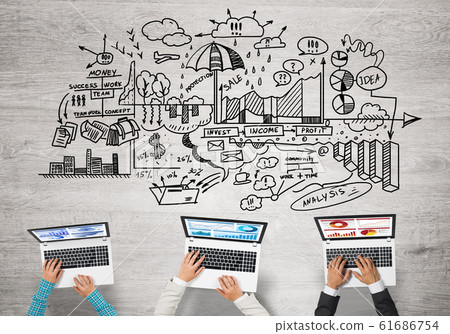 Top view of businesspeople sitting at table and using gadgets Top view of businesspeople sitting at table and using gadgets 61686754