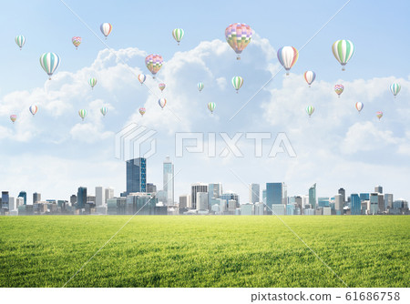 Concept of eco green life with aerostats flying above city Concept of eco green life with aerostats flying above city 61686758