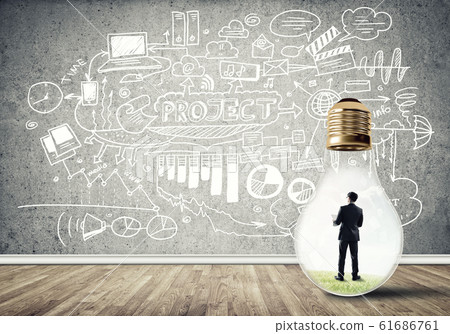 Businessman trapped in bulb Businessman trapped in bulb 61686761