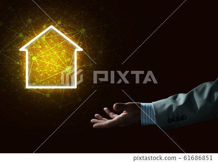 Conceptual image with hand pointing at house or main page icon o 61686851