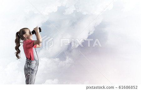 Concept of careless happy childhood with girl looking in binocul Concept of careless happy childhood with girl looking in binocul 61686852