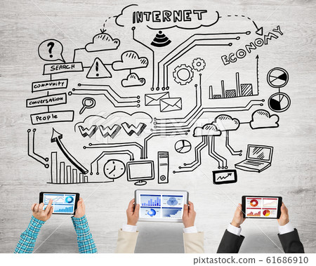Top view of businesspeople sitting at table and using gadgets Top view of businesspeople sitting at table and using gadgets 61686910
