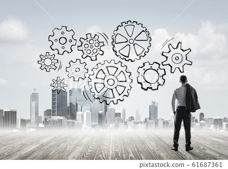 Cogwheel engine drawn on screen as symbol for teamwork and coope Cogwheel engine drawn on screen as symbol for teamwork and coope 61687361