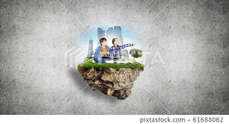 Two kids of school age with book exploring this great world 61688062