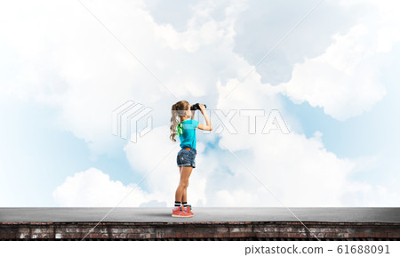 Concept of careless happy childhood with girl of school age looking in future Concept of careless happy childhood with girl of school age looking in future 61688091