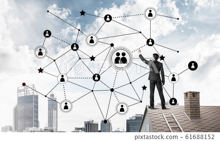 Businessman on house roof presenting networking and connection c 61688152