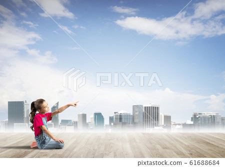 Concept of careless happy childhood with girl dreaming about something Concept of careless happy childhood with girl dreaming about something 61688684