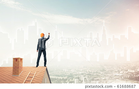 Man architect draw silhouette of modern city on blue sky. Mixed Man architect draw silhouette of modern city on blue sky. Mixed 61688687