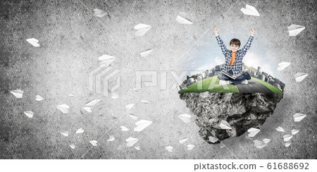 Cute boy of school age with book exploring this great world Cute boy of school age with book exploring this great world 61688692