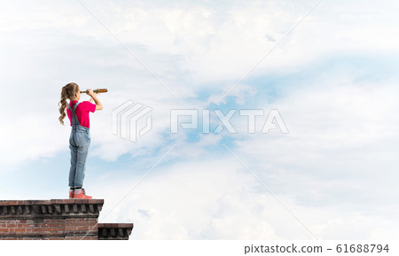 Concept of careless happy childhood with girl exploring this world 61688794